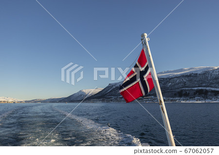 Norwegian flag with fjords on the background 67062057
