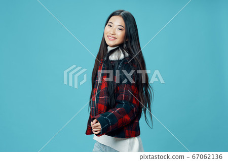 Beautiful woman in a warm jacket smiles at the camera Beautiful woman in a warm jacket smiles at the camera 67062136
