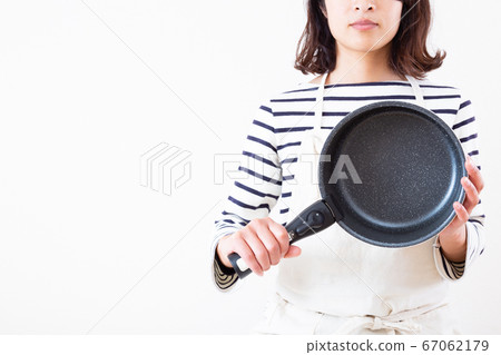 A woman with a frying pan A woman with a frying pan 67062179
