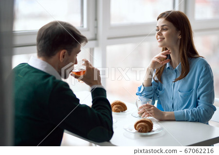 happy man and woman in restaurant croissants breakfast loving couple happy man and woman in restaurant croissants breakfast loving couple 67062216