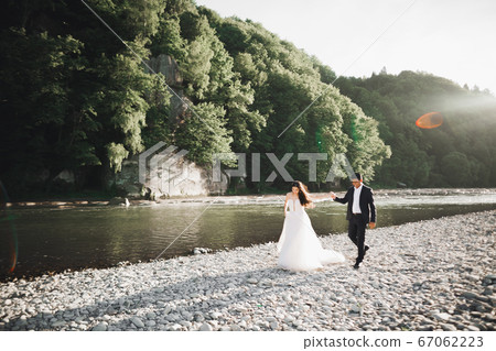 Wedding couple holding hands, groom and bride together on wedding day 67062223