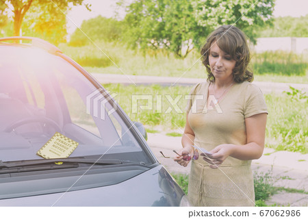 woman holding parking ticket 67062986