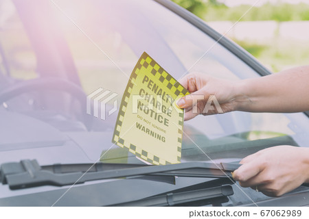 Parking ticket placed under windshield 67062989