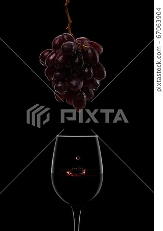 dark wet ripe grape bunch and wine glasses isolated on black 67063904