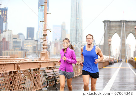 Runners couple running in New York Runners couple running in New York 67064348