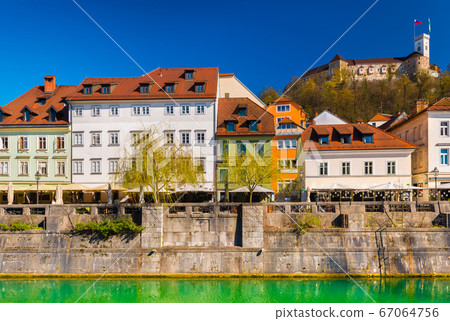 Beautiful cityscape of Ljubljana with colorful historical buildings and the Castle in the background Beautiful cityscape of Ljubljana with colorful historical buildings and the Castle in the background 67064756