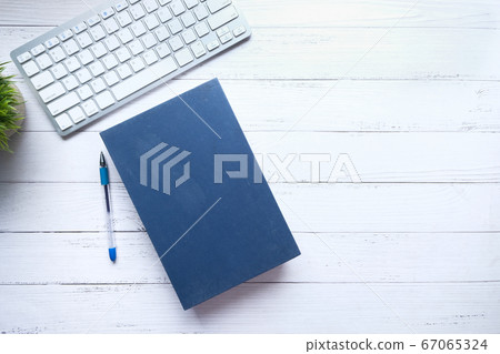 book with empty cover, pen and keyboard on table book with empty cover, pen and keyboard on table 67065324