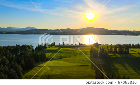 Aerial view over Lake Forggensee at the city of Fuessen in Germany Aerial view over Lake Forggensee at the city of Fuessen in Germany 67065816