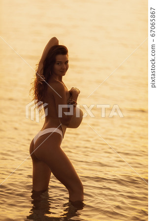 Tanned Woman Resting in Water During Summer Vacations Tanned Woman Resting in Water During Summer Vacations 67065867