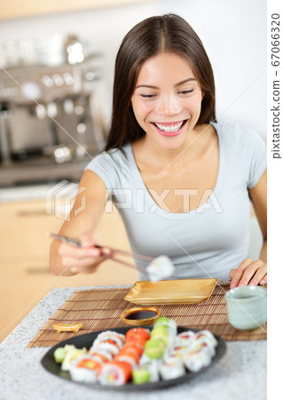 Asian young woman taking healthy lifestyle sushi 67066320