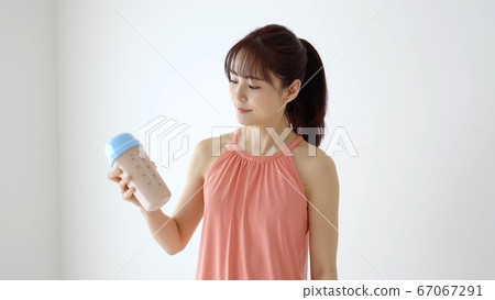 Woman drinking protein Woman drinking protein 67067291
