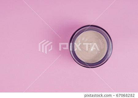 Open jar with face cream on a pink background. Face care concept Open jar with face cream on a pink background. Face care concept 67068282