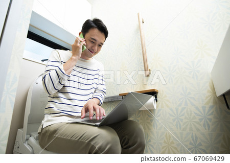 Telework in a toilet 67069429