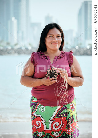 Portrait Of Indigenous Woman Showing Off Woven Coaster 67070542