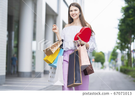 A woman holding many shopping bags A woman holding many shopping bags 67071013