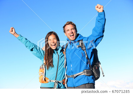 Happy hiking couple cheering Happy hiking couple cheering 67071285