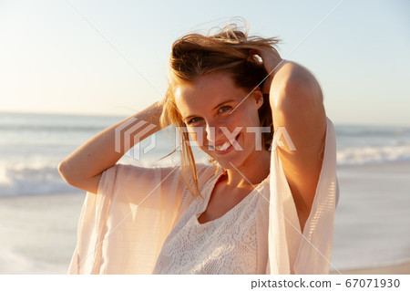 Portrait of beautiful woman smiling on the beach 67071930