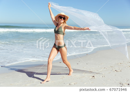 Beautiful woman enjoying on the beach 67071946