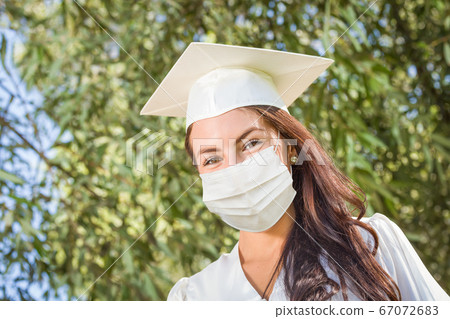 Female Graduate in Cap and Gown Wearing Medical Face Mask Female Graduate in Cap and Gown Wearing Medical Face Mask 67072683