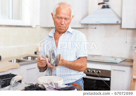 Senior man with mixer tap Senior man with mixer tap 67072899