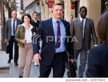 Business man walking on city street Business man walking on city street 67073441