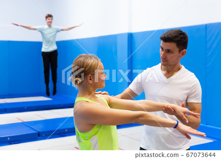 People warming up before trampoline training People warming up before trampoline training 67073644