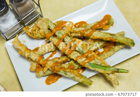 Asparagus fried in batter with romesco sauce Asparagus fried in batter with romesco sauce 67073717