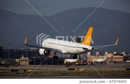 Airplane lands at the airport of Barcelona. Spain 67074005