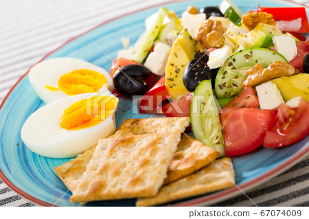 Vegetable salad with crackers and boiled egg Vegetable salad with crackers and boiled egg 67074009