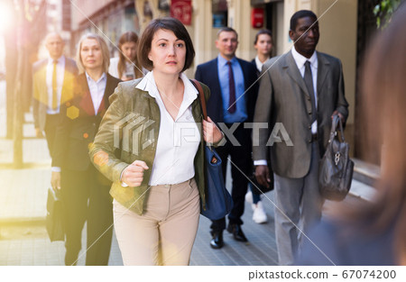 Woman in business suit hurry up 67074200