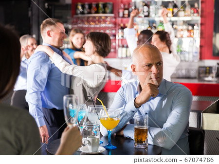 Sad bored man at corporate party Sad bored man at corporate party 67074786
