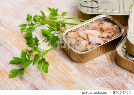 Chopped tuna belly in tin cans with greens Chopped tuna belly in tin cans with greens 67074793