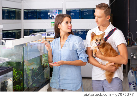 Woman and boy looking at aquarium with fish 67075377