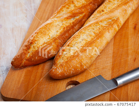 Closeup of crunchy french baked baguettes, bakery products Closeup of crunchy french baked baguettes, bakery products 67075417