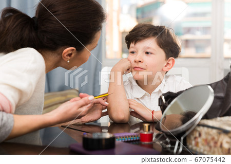 Dreamy boy listening to mother 67075442