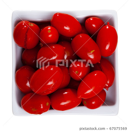 Juicy marinated tomatoes on a white plate. Homemade canning. Pickled vegetables Juicy marinated tomatoes on a white plate. Homemade canning. Pickled vegetables 67075569