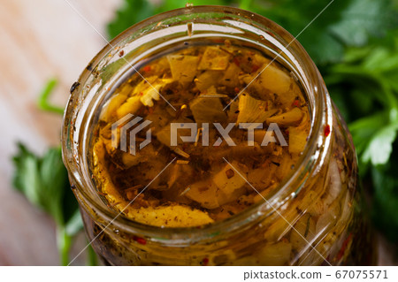 Spicy pickled herring fillets in glass jar Spicy pickled herring fillets in glass jar 67075571