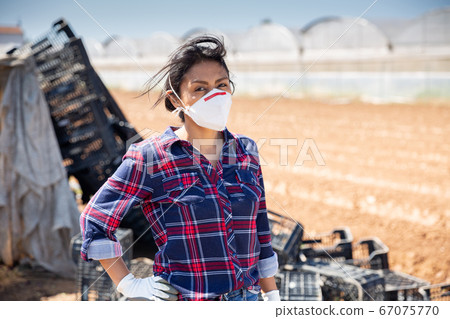 Hispanic female farmer in medical face mask 67075770