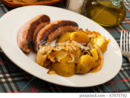 Grilled sausages with potatoes Grilled sausages with potatoes 67075792