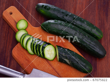 Whole and sliced fresh cucumbers Whole and sliced fresh cucumbers 67075822