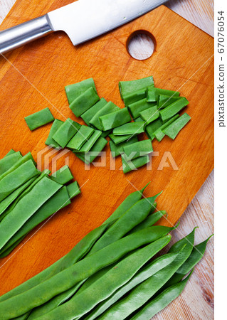 Sliced green beans on a wooden board Sliced green beans on a wooden board 67076054