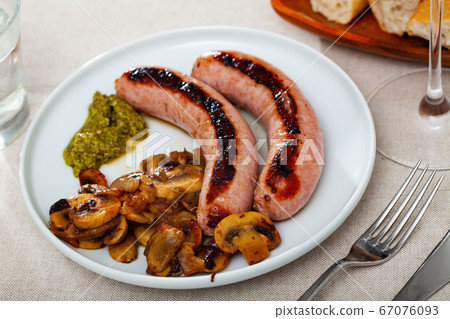 Roasted sausages with mushrooms Roasted sausages with mushrooms 67076093