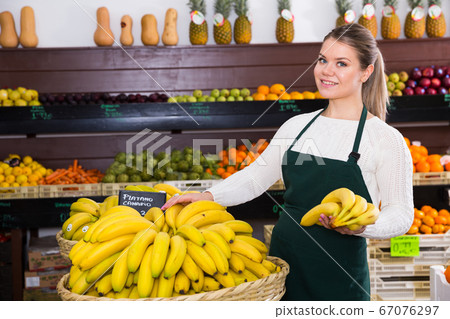 Salesgirl proposing bananas 67076297