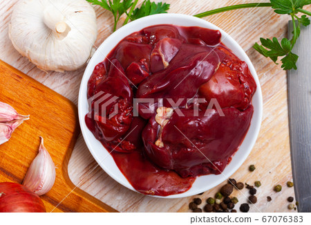 Chicken liver ready for cooking on cutting board Chicken liver ready for cooking on cutting board 67076383