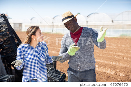 Puzzled workwoman talking to farmer 67076470