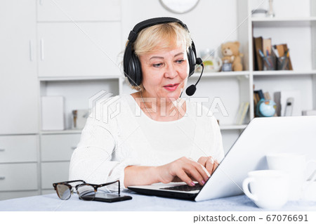 Mature woman communicates via the Internet Mature woman communicates via the Internet 67076691