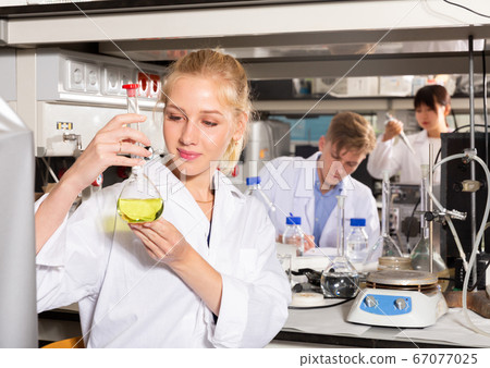 Female lab technician working with reagents Female lab technician working with reagents 67077025