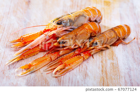 Several lobsters on wooden table Several lobsters on wooden table 67077124
