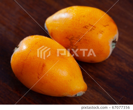 Ripe medlar fruits nispero on wooden surface 67077356