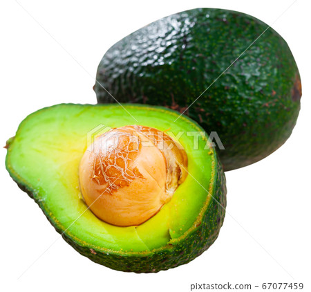 Whole and halved avocados 67077459